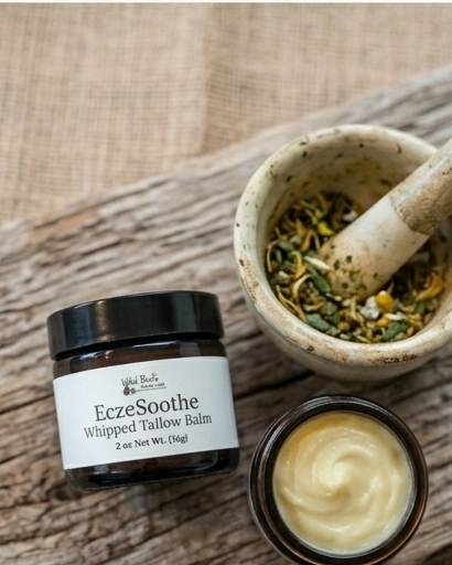 Eczesothe whipped tallow balm jar with a mortar and pestle on a wooden surface