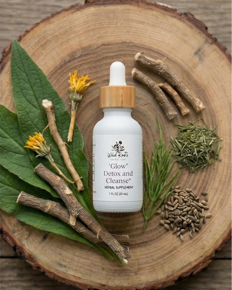 White bottle with wooden dropper on a wooden surface with herbs and leaves