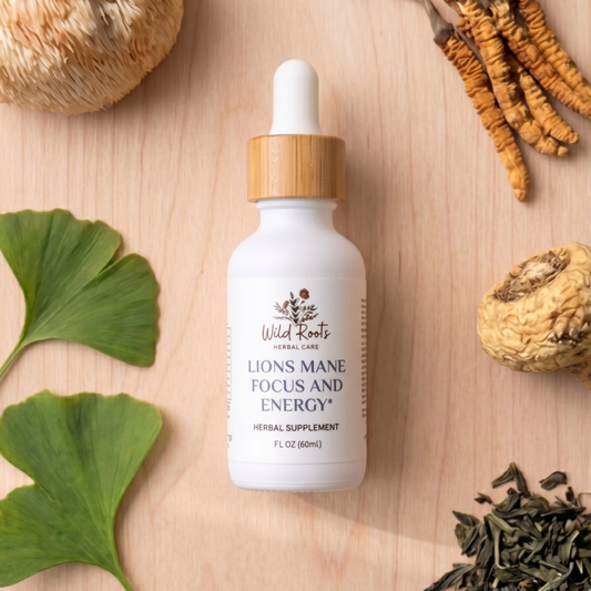 White bottle with wooden dropper labeled 'Lions Mane Focus and Energy' on a wooden surface with ginkgo biloba leaves and dried herbs.